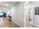 Bright hallway with wood-look tile, leading to bedrooms and a convenient bathroom at 181 Sierra Alta Pl, Henderson, NV 89015