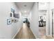 Long hallway with neutral walls, decorative picture frames, and recessed lighting at 181 Sierra Alta Pl, Henderson, NV 89015