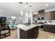 Open concept kitchen with stainless steel appliances and an island overlooking the living area at 181 Sierra Alta Pl, Henderson, NV 89015