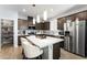 Modern kitchen with stainless steel appliances, a pantry, and a large white island at 181 Sierra Alta Pl, Henderson, NV 89015