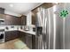 This kitchen includes stainless steel appliances, white countertops, and dark cabinets at 181 Sierra Alta Pl, Henderson, NV 89015