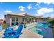 Backyard pool with tanning shelf, covered patio, and mountain views at 181 Sierra Alta Pl, Henderson, NV 89015