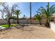 The home's backyard features gravel, mature trees, and artificial turf at 2004 Burnham Ave, Las Vegas, NV 89104