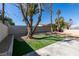 A well kept backyard features gravel, artificial turf, and mature trees at 2004 Burnham Ave, Las Vegas, NV 89104