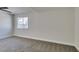 A bright bedroom features a window and neutral carpet at 2004 Burnham Ave, Las Vegas, NV 89104