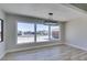 Bright dining area with wood-look flooring, modern light fixture, and large windows at 2004 Burnham Ave, Las Vegas, NV 89104