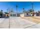 Single-story home with a large driveway and desert landscaping in the front yard at 2004 Burnham Ave, Las Vegas, NV 89104