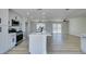 Bright and airy kitchen featuring an island, quartz countertops, stainless appliances, and wood-look flooring at 2004 Burnham Ave, Las Vegas, NV 89104