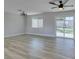 Bright living room with wood-look floors, modern lighting, and sliding glass doors to the backyard at 2004 Burnham Ave, Las Vegas, NV 89104