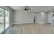 Spacious living room with wood floors, ceiling fan, and sliding glass doors to the backyard at 2004 Burnham Ave, Las Vegas, NV 89104