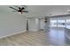 Bright living room with wood floors and a ceiling fan, seamlessly connecting to the kitchen area at 2004 Burnham Ave, Las Vegas, NV 89104