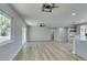 Open-concept living room with wood-look flooring and abundant natural light from large sliding glass doors and windows at 2004 Burnham Ave, Las Vegas, NV 89104