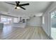 Bright living room with wood floors connecting the kitchen and access to a backyard patio with sliders at 2004 Burnham Ave, Las Vegas, NV 89104