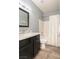 Modern bathroom featuring a vanity with marble countertop, tiled floors, and shower at 2421 Sunrise Springs Ct, North Las Vegas, NV 89031