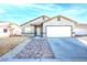 Charming single-story home with a two-car garage and manicured front yard at 2421 Sunrise Springs Ct, North Las Vegas, NV 89031