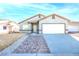 Charming single-story home with a well-manicured front yard, paved walkway, and attached garage at 2421 Sunrise Springs Ct, North Las Vegas, NV 89031