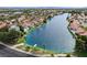 Aerial view of a community with homes surrounding a beautiful lagoon with docks, boats, and lush landscaping at 2504 Cove Rd, Las Vegas, NV 89128