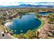 Elevated view showcasing a community with a winding lagoon and mountain views, surrounded by lush trees at 2504 Cove Rd, Las Vegas, NV 89128