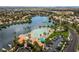 Beautiful aerial view of a community lake and clubhouse with beach area at 2504 Cove Rd, Las Vegas, NV 89128