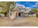 Exterior of home featuring the backyard patio with shade and seating area at 2504 Cove Rd, Las Vegas, NV 89128