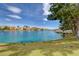 A serene view of the lagoon from a grassy backyard, enhanced by birds and lush landscaping at 2504 Cove Rd, Las Vegas, NV 89128