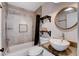 Bathroom with a white sink, shelves, and tiled shower at 2504 Cove Rd, Las Vegas, NV 89128