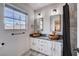 This bathroom features modern sinks, dual mirrors, and a large window at 2504 Cove Rd, Las Vegas, NV 89128