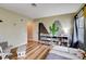 Bright bedroom with mountain and desert mural, wood floors, storage shelves, and chair at 2504 Cove Rd, Las Vegas, NV 89128