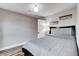 Bedroom with gray bedding, neutral walls, and wood-look floors at 2504 Cove Rd, Las Vegas, NV 89128