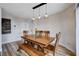 Dining room featuring hardwood floors, modern lighting, and seating for six at 2504 Cove Rd, Las Vegas, NV 89128