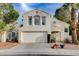 Charming two-story home featuring a spacious two car garage and landscaped front yard at 2504 Cove Rd, Las Vegas, NV 89128