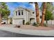 Two story home features an attached garage and xeriscaped front yard at 2504 Cove Rd, Las Vegas, NV 89128