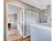 Hallway with wood floors, white trim, and a large closet with bifold doors at 2504 Cove Rd, Las Vegas, NV 89128