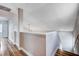 Hallway with wood floor, white trim, leading up to a landing with a vaulted ceiling at 2504 Cove Rd, Las Vegas, NV 89128