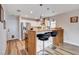 Kitchen featuring stainless steel appliances, breakfast bar, and hardwood floors at 2504 Cove Rd, Las Vegas, NV 89128