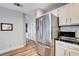 Kitchen area with stainless steel refrigerator, ample cabinet space, and tiled backsplash at 2504 Cove Rd, Las Vegas, NV 89128