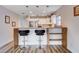 Kitchen featuring stainless steel appliances, breakfast bar, and hardwood floors at 2504 Cove Rd, Las Vegas, NV 89128