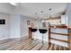 View of kitchen featuring wooden breakfast bar with seating, stainless steel appliances, and updated lighting at 2504 Cove Rd, Las Vegas, NV 89128