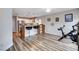 Open-concept with breakfast bar and stools leading to the kitchen featuring stainless steel appliances at 2504 Cove Rd, Las Vegas, NV 89128