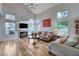 Sunlit living room boasts a fireplace and views of the landscaped yard at 2504 Cove Rd, Las Vegas, NV 89128