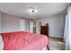 Main bedroom with wood-look floors, large windows, dresser, and neutral walls at 2504 Cove Rd, Las Vegas, NV 89128