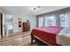 Main bedroom with wood-look floors and many windows for natural light, and access to the en suite at 2504 Cove Rd, Las Vegas, NV 89128