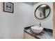 Well-lit powder room featuring modern fixtures and a round mirror at 2504 Cove Rd, Las Vegas, NV 89128