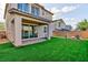 The backyard features a covered patio, artificial turf, and a block wall, offering a private and enjoyable outdoor living area at 26 Lilla Rosa St, Henderson, NV 89011