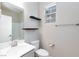 Bathroom with light gray vanity, decorative shelves, and a shower with glass doors at 26 Lilla Rosa St, Henderson, NV 89011