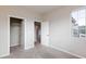 Bedroom with neutral walls, carpet floors, a large window and two closets at 26 Lilla Rosa St, Henderson, NV 89011