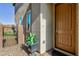 A charming front entrance features a decorative brown front door, manicured landscaping, and a gravel walkway at 26 Lilla Rosa St, Henderson, NV 89011