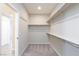 Walk-in closet with shelving, and carpet flooring at 26 Lilla Rosa St, Henderson, NV 89011