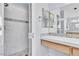 Elegant bathroom featuring a walk-in shower with white marble tiles and a double vanity with modern mirrors at 2638 Douglas Cir, Henderson, NV 89074