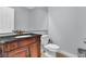 Stylish half bathroom featuring a marble countertop vanity with antique-style faucet at 2638 Douglas Cir, Henderson, NV 89074